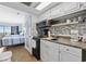 Compact kitchen area featuring sleek appliances and a breakfast bar next to the bedroom at 2000 S Ocean Blvd. # V405, Myrtle Beach, SC 29577