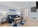 Cozy living room with a comfortable blue sofa, wooden coffee table, and beach-themed artwork at 2000 S Ocean Blvd. # V405, Myrtle Beach, SC 29577