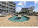 Unique pool design with a center island, surrounded by lounge chairs at 2000 S Ocean Blvd. # V405, Myrtle Beach, SC 29577