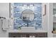 Bathroom featuring stylish vanity with square sink, round mirror, and tiled accent wall at 2001 S Ocean Blvd. # 1408, Myrtle Beach, SC 29577