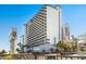 Exterior shot featuring the pool area and well-maintained landscaping of the hotel at 2001 S Ocean Blvd. # 1408, Myrtle Beach, SC 29577