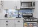 Efficient kitchen offers white cabinets, marble countertops, stainless appliances, and a tiled backsplash at 2001 S Ocean Blvd. # 1408, Myrtle Beach, SC 29577
