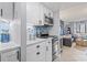 Well-lit kitchen boasts marble counters, blue backsplash, stainless steel appliances, and convenient access to living room at 2001 S Ocean Blvd. # 1408, Myrtle Beach, SC 29577