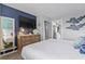 Bedroom featuring dresser with TV, closet and nautical decor, conveniently located near the kitchen at 2001 S Ocean Blvd. # 1408, Myrtle Beach, SC 29577