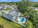 Aerial view of private backyard oasis with pool, patio, mature trees, and fenced yard at 2010 Chattooga Ct., Myrtle Beach, SC 29588