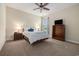 Bedroom has cozy carpet, a ceiling fan, and matching wood nightstands at 2010 Chattooga Ct., Myrtle Beach, SC 29588