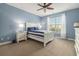 Bedroom features blue walls, a ceiling fan, and natural light from a window at 2010 Chattooga Ct., Myrtle Beach, SC 29588