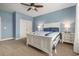 Spacious bedroom with a white bed, blue walls, and a ceiling fan at 2010 Chattooga Ct., Myrtle Beach, SC 29588