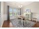 Classic dining room with natural light and modern chandelier. Includes rug and wainscoting at 2010 Chattooga Ct., Myrtle Beach, SC 29588