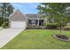 Charming single Gathering home with brick and vinyl siding, manicured lawn and front porch bench at 2010 Chattooga Ct., Myrtle Beach, SC 29588