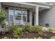 Charming front porch with a white bench and lush landscaping for curb appeal at 2010 Chattooga Ct., Myrtle Beach, SC 29588