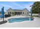 Backyard with inground pool, patio, seating area, screened in porch, and grill at 2010 Chattooga Ct., Myrtle Beach, SC 29588