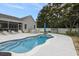 Backyard with inground pool, patio, seating area, screened in porch, and white vinyl privacy fence at 2010 Chattooga Ct., Myrtle Beach, SC 29588