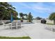Backyard with inground pool, patio, seating area, white vinyl privacy fence, and mature trees at 2010 Chattooga Ct., Myrtle Beach, SC 29588