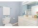 A well-lit bathroom with a vanity sink, a functional toilet, and neutral tile flooring at 2060 Cross Gate Blvd. # 102, Surfside Beach, SC 29575