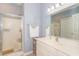 Bathroom featuring glass shower door, vanity and a large mirror at 2060 Cross Gate Blvd. # 102, Surfside Beach, SC 29575
