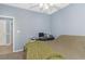 Neutral bedroom with light blue walls, plush carpet flooring, and an organized work-from-home space at 2060 Cross Gate Blvd. # 102, Surfside Beach, SC 29575