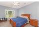 Cozy bedroom with a ceiling fan, natural light and two wood nightstands at 2060 Cross Gate Blvd. # 102, Surfside Beach, SC 29575