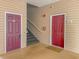 Exterior of a building with wood paneled walls, stairs, and crimson doors to condos at 2060 Cross Gate Blvd. # 102, Surfside Beach, SC 29575