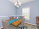 Stylish dining room featuring a unique table with upholstered chairs and natural lighting at 2060 Cross Gate Blvd. # 102, Surfside Beach, SC 29575
