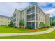 Exterior view of condo building featuring screened-in porches and well-maintained landscaping at 2060 Cross Gate Blvd. # 102, Surfside Beach, SC 29575
