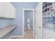 Inviting laundry room with washer, dryer, shelving, and cabinets with convenient access to the commode at 2060 Cross Gate Blvd. # 102, Surfside Beach, SC 29575