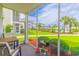 Relaxing screened-in patio featuring a view of the lush community landscape at 2060 Cross Gate Blvd. # 102, Surfside Beach, SC 29575