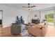 Bright living room with hardwood floors, comfortable seating, and a sliding glass door at 228 Averyville Dr., Conway, SC 29526