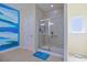Bathroom featuring a shower with a glass door and tiled walls, with white door and blue accent wall at 232 Angel Wing Dr., Myrtle Beach, SC 29588