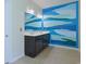 Bathroom featuring double vanity, stylish mirrors, and a unique blue and white accent wall at 232 Angel Wing Dr., Myrtle Beach, SC 29588