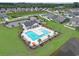 Aerial view of the community pool with lounge chairs and umbrellas, surrounded by a lake at 232 Angel Wing Dr., Myrtle Beach, SC 29588