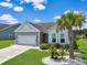 Charming single-story home with a manicured lawn and vibrant landscaping under a sunny sky at 232 Angel Wing Dr., Myrtle Beach, SC 29588