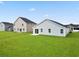 New construction home's backyard featuring a freshly sodded lawn and neighboring houses at 24 Cape Point Dr., Conway, SC 29527