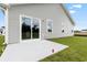 Concrete patio in the backyard of a new home featuring light gray siding and a sliding glass door at 24 Cape Point Dr., Conway, SC 29527