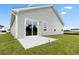 Backyard with a concrete patio and a newly constructed home featuring light gray siding at 24 Cape Point Dr., Conway, SC 29527