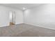 Bedroom with neutral carpet, white walls, and a doorway leading to the vinyl floored hallway at 24 Cape Point Dr., Conway, SC 29527
