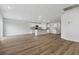 Open-concept living room and kitchen with white cabinets, granite counters, stainless appliances, and wood floors at 24 Cape Point Dr., Conway, SC 29527