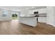 An open-concept living room and kitchen area with wood floors and modern fixtures at 24 Cape Point Dr., Conway, SC 29527