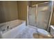 Bathroom features a tiled floor, soaking tub, and a glass-enclosed shower at 244 Colby Ct., Myrtle Beach, SC 29588