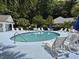 Relaxing community pool area with lounge chairs and tables for residents to enjoy at 244 Colby Ct., Myrtle Beach, SC 29588
