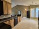 Well-equipped kitchen with tile floors, black appliances, light wood cabinets and convenient breakfast bar at 244 Colby Ct., Myrtle Beach, SC 29588