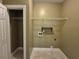A well-lit laundry room with tiled floor, shelving and hookups for appliances at 244 Colby Ct., Myrtle Beach, SC 29588