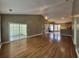 Open-concept floor plan with hardwood floors, sliding glass doors and view of dining area and kitchen at 244 Colby Ct., Myrtle Beach, SC 29588