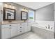 Bathroom with double vanity, soaking tub, and tile flooring at 250 Penn Circle, Galivants Ferry, SC 29544