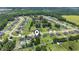 An aerial view of a community with well-maintained lawns and neatly arranged homes, and surrounding trees at 250 Penn Circle, Galivants Ferry, SC 29544