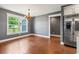 Bright dining area featuring a modern chandelier, a large window, and hardwood floors at 250 Penn Circle, Galivants Ferry, SC 29544