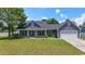 Charming single-story home with gray siding, a manicured lawn, and an attached two-car garage at 250 Penn Circle, Galivants Ferry, SC 29544