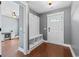 A welcoming foyer with hardwood floors and a built in mud bench. Light and neutral walls at 250 Penn Circle, Galivants Ferry, SC 29544