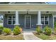 Inviting front porch with stone-based columns and walkway, offers a warm welcome to this charming home at 250 Penn Circle, Galivants Ferry, SC 29544