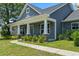 Close up view of a charming front porch featuring stone pillars and decorative trim at 250 Penn Circle, Galivants Ferry, SC 29544